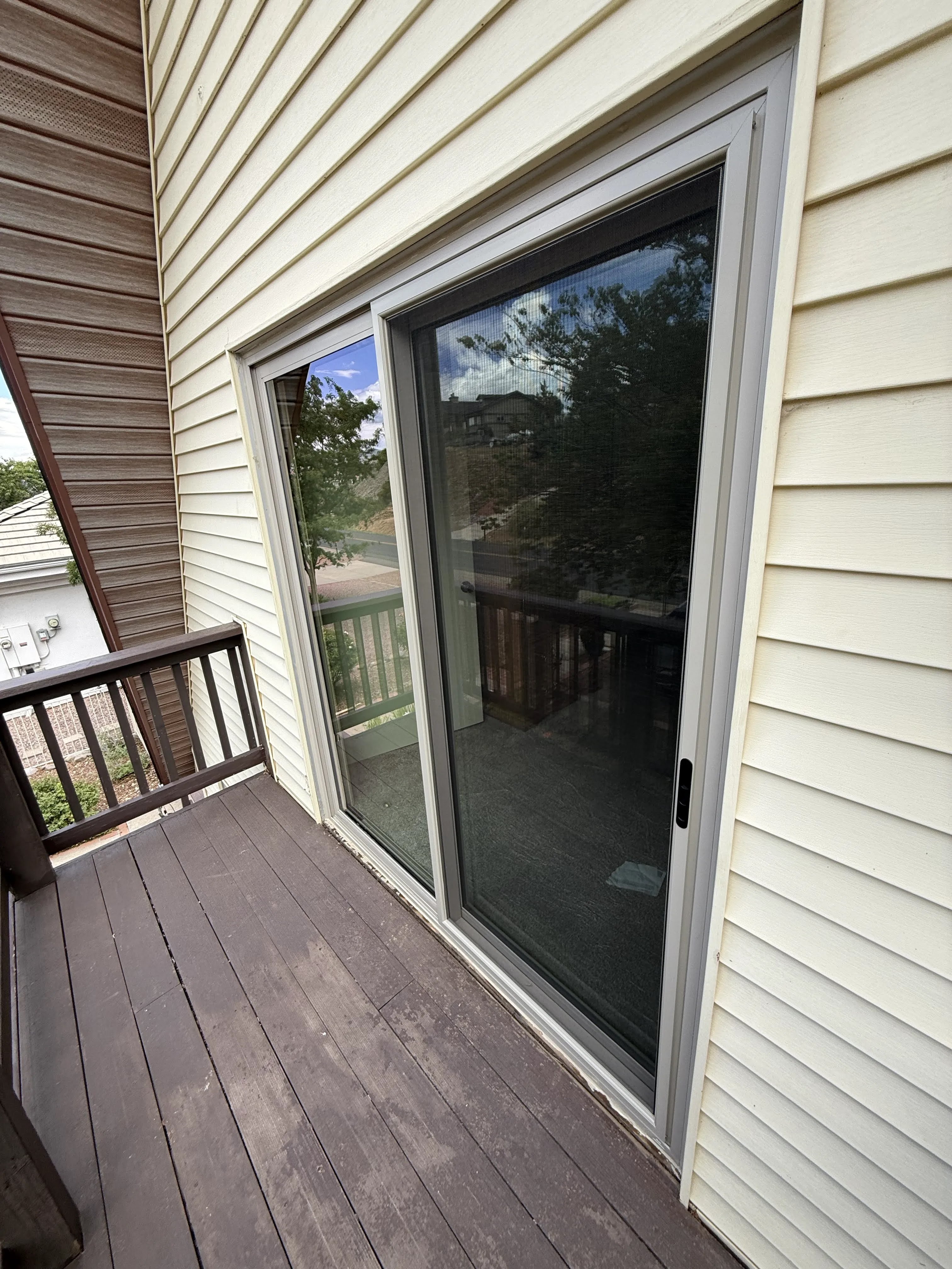New sliding patio door viewed from the balcony of the A-frame home