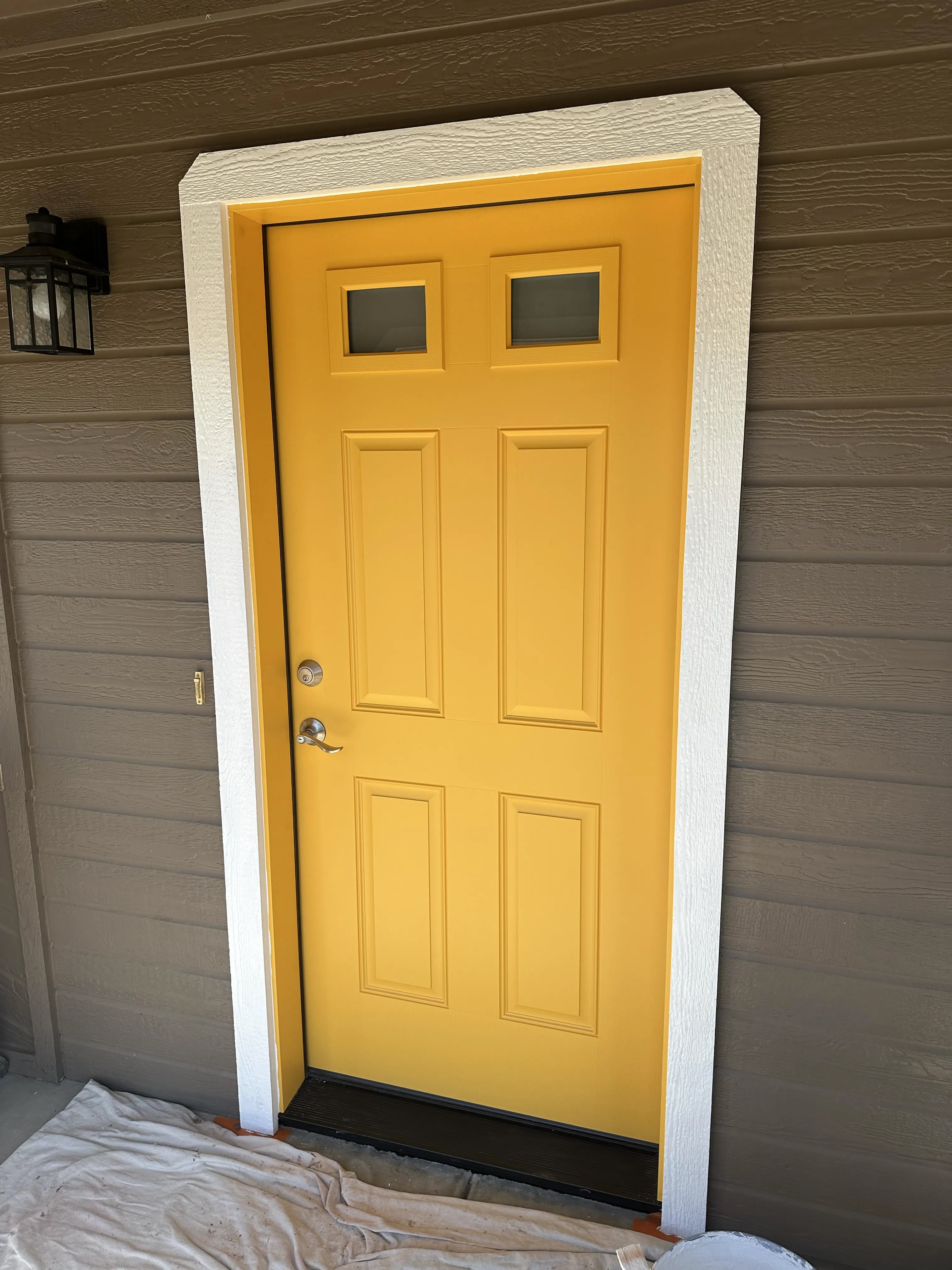 Newly installed yellow exterior entry door