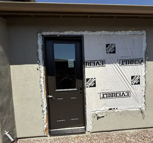 Exterior wall opening converted from a window to a new entry door